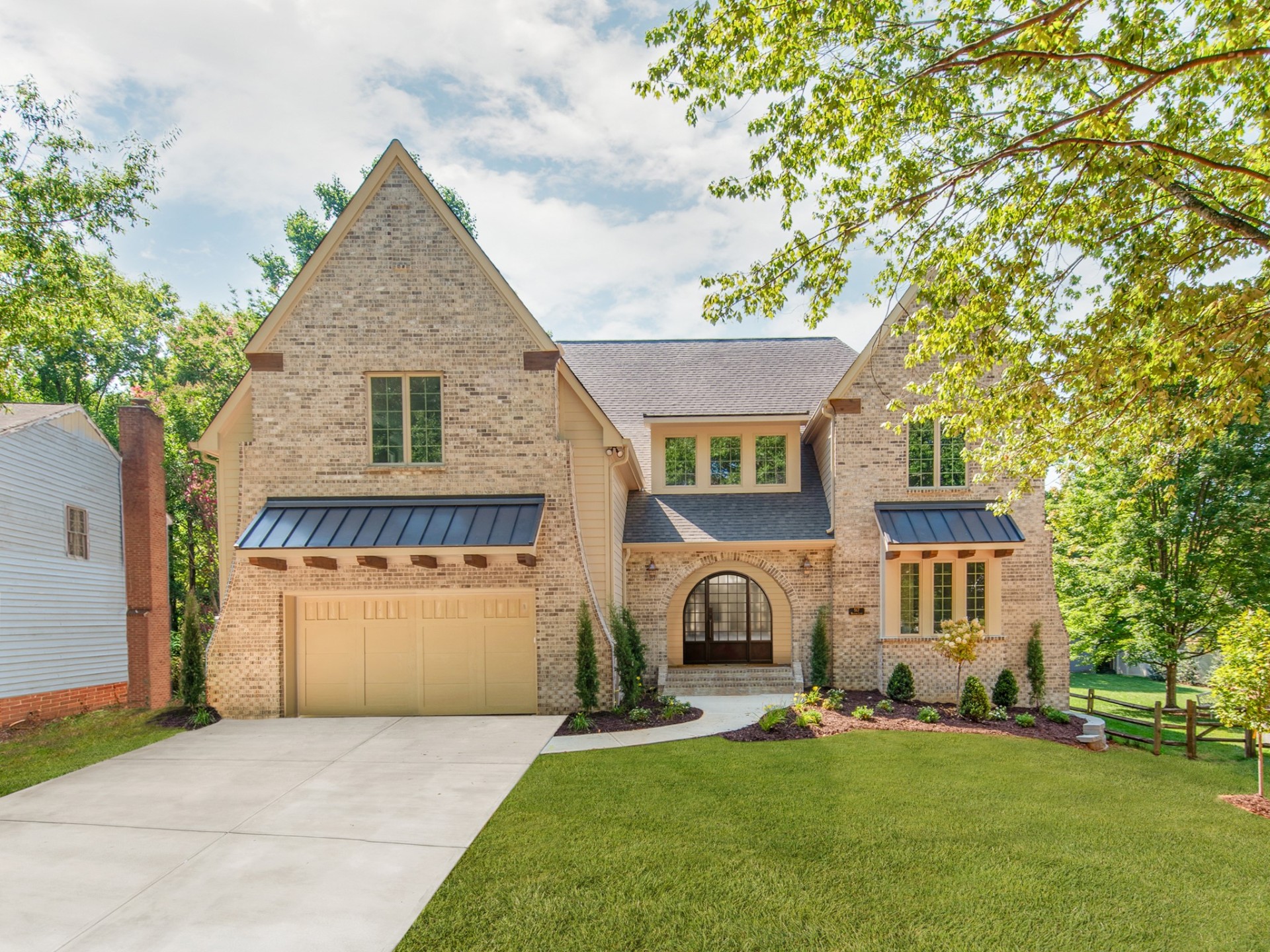 Montford — front elevation with arched entry and metal awnings